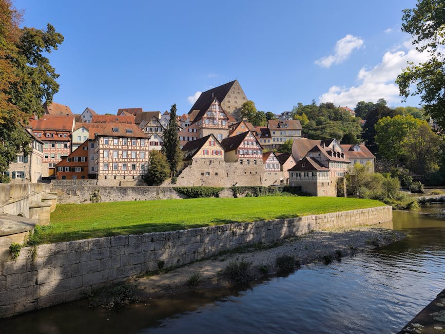 Picturesque view of half-timbered houses by a river during a sunny day.